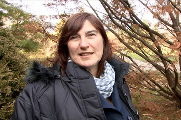 Photo of Céline Arseneault, ccoordinator of the exhibit Trees Inside Out, in the Arboretum of the Jardin botanique de Montréal